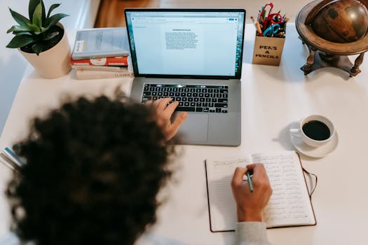 pexels photo 6393024 6393024 From above of anonymous writer using portable computer with text on screen at table with hot drink and diary